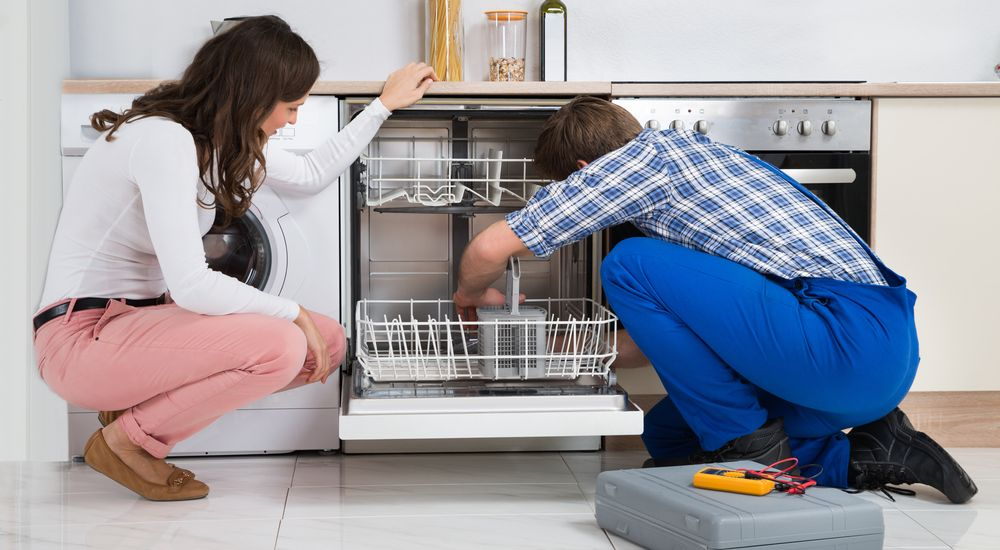 GRIT appliance repair technician working with customer on dishwasher repair Abilene