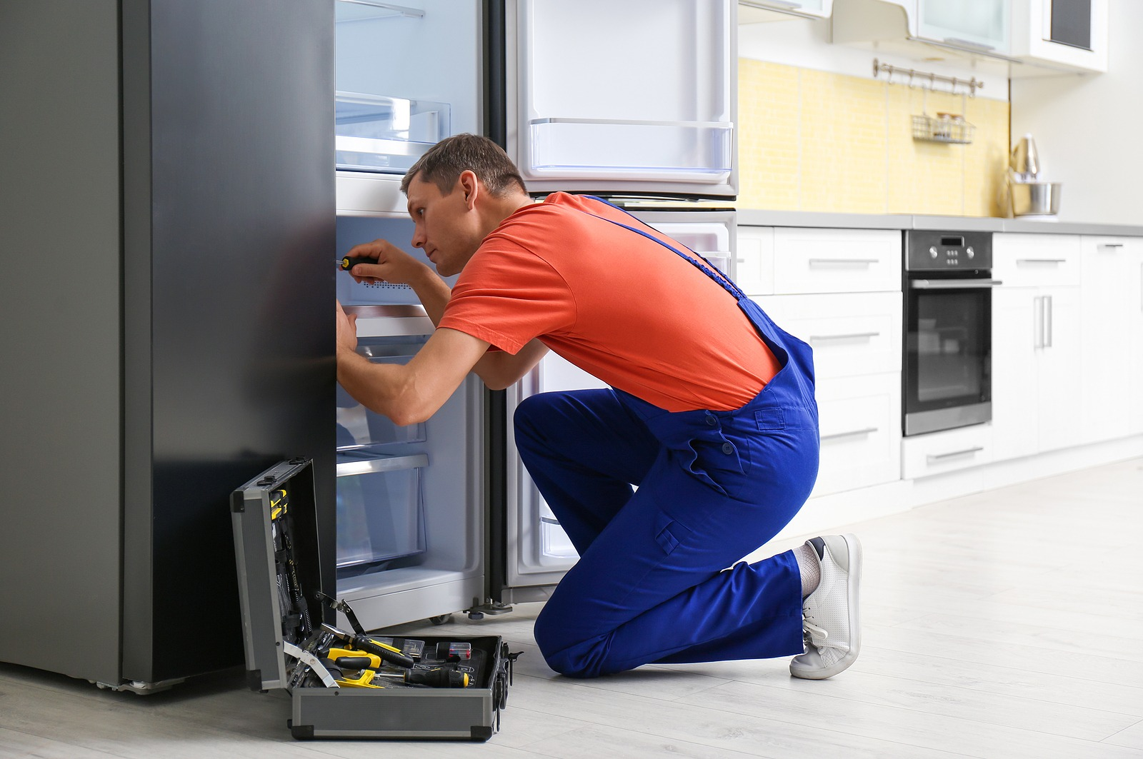 GRIT appliance repair technician servicing refrigerator in Abilene Texas