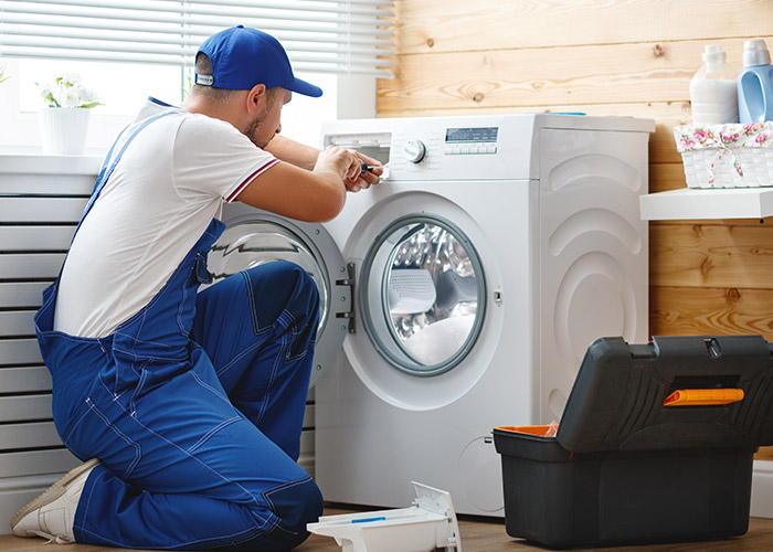 GRIT Technician Repairing Washing Machine